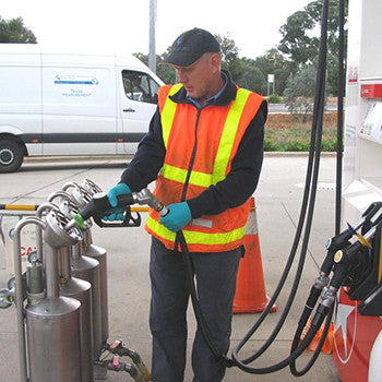 man using a fuel dispenser